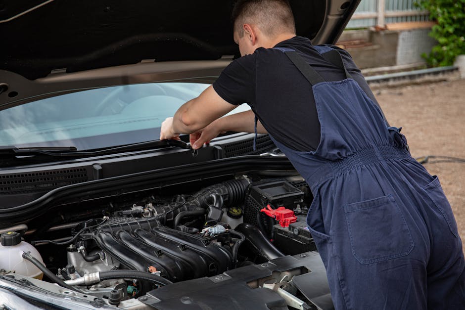 Mechanic fixing car window and performing chip repair
